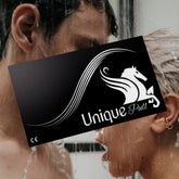 Two people standing close together in an intimate moment under running water. A black banner with a white horse logo and the text "Unique 'Pull' Latex-Free Condoms" partially covers their faces.